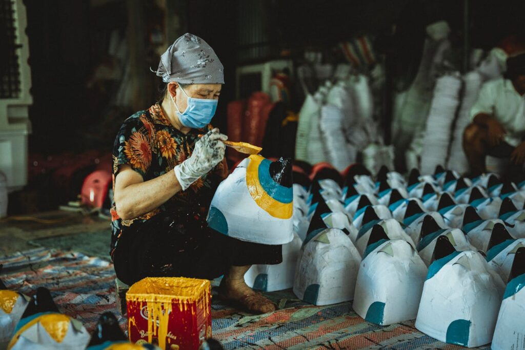 A woman in a face mask is working on a table