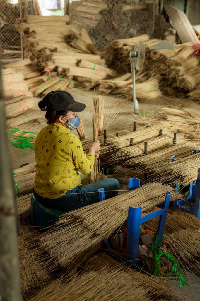 A woman is working on a basket in a factory